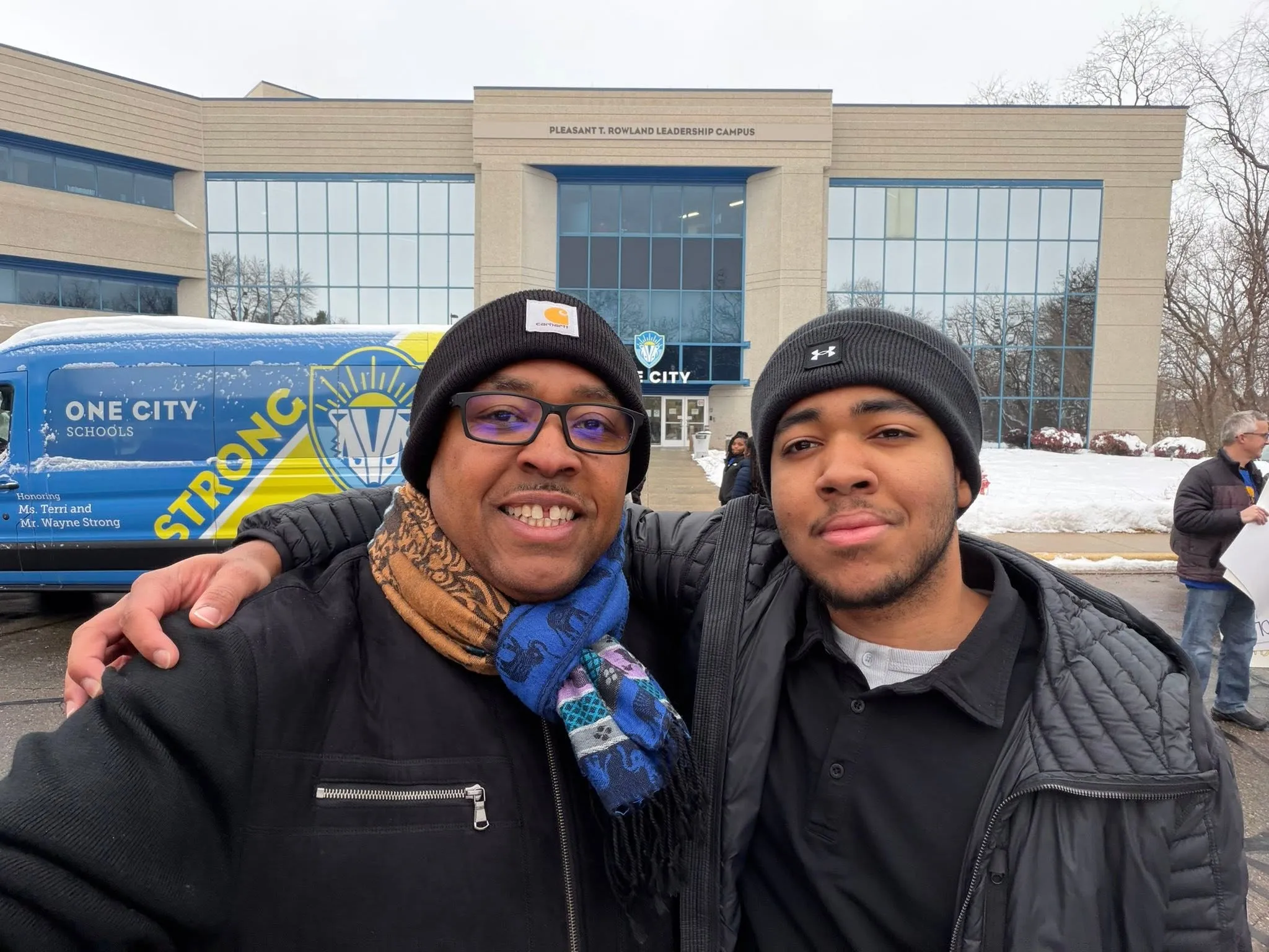 Kaleem Caire and his son outside One City Schools’ Pleasant T. Rowland Leadership Campus